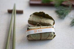 Salmon sushi wrapped in leaves
