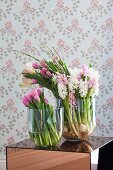 Pink tulips, lisianthus and hyacinths in glass vases