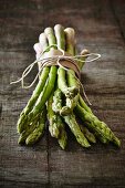 Fresh green asparagus on a wooden board