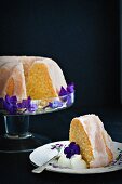 Lemon Bundt cake decorated with violets, sliced
