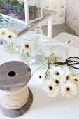 White gerbera daisies, small glass vases, vintage reel of string and garden scissors