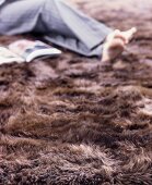 Cosy seating area on brown fur rug