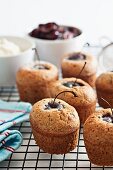 Friands with cherries on a wire rack