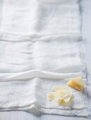 A piece of Parmesan and grated Parmesan on a muslin cloth