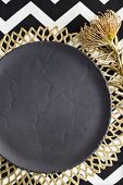 Grey plate on gold place mat (festive)