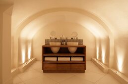 Wooden washstand with integrated basins in designer bathroom