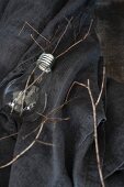 Light bulb repurposed as vase holding twigs