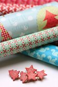 Rolls of various wrapping papers and pegs with numbers for DIY Advent calender