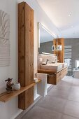 A made-to-measure wooden cupboard next to a washstand in a modern bathroom