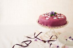 A cake with a violet marzipan coating