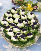 Cucumber slices with cream cheese and caviar for a mid-summer festival