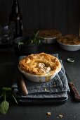 A chicken and mushroom pie in a white baking dish