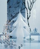 Room festively decorated in white with candelabra, baubles and white Christmas tree