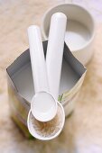 Rice milk in a carton with a spoonful of rice