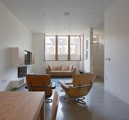 Open-plan, designer lounge area with low sideboard and upholstered seating