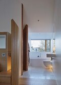 Designer-style ensuite bathroom with sliding windows and mosaic tiles