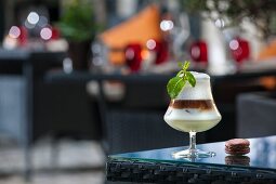 An Irish coffee cocktail on a patio table (Buddha-Bar Hotel, Paris)