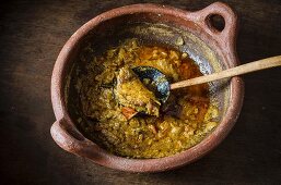 Fish curry in a terracotta pot (Asia)