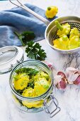 Patty pan squashes with herbs in a preserving jar