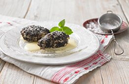 Apple and quark dumplings with poppyseeds and vanilla sauce