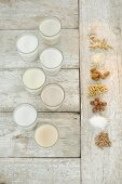 Various types of lactose-free milk in glasses (seen from above)