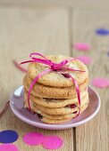 A stack of strawberry cookies tied with a ribbon