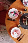 Round wooden table with folkloric crosses and name tags