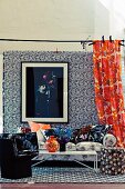 Living room with a mix of floral patterns on wallpaper, curtain, sofa and pillows