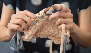 A woman knooking – knitting with a hook