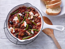 Fried minced meat with beans, olives and sheep's cheese