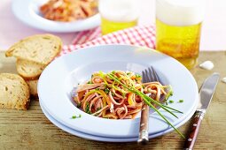 Sausage salad with vegetables and chives