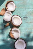 Broken coconuts on a wooden board in sunlight
