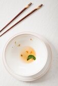 An oriental arrangement featuring an empty soup bowl and chopsticks