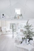 White Christmas arrangement with Christmas tree and branches in white interior