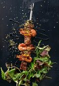 Beef and prawns skewers with salad