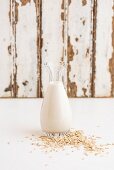 Oats and a bottle of oat milk