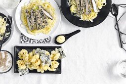 Hähnchenbrust mit Sesamkruste auf Udonnudel-Salat und Tintenfischringe im Maisteig