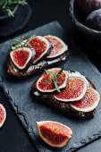 Slices of bread topped with cream cheese and figs