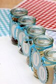 Nuts, seeds & dried fruits in storage jars with hand-crafted labels