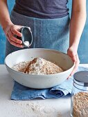 Spelt wholemeal bread being made: ingredients being mixed in a bowl