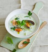 Cream of potato soup with celery and fresh mussels
