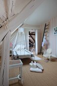 Bed with white, wrought iron frame and canopy on sisal carpet