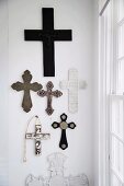 Various religious crosses on wall in corner of room