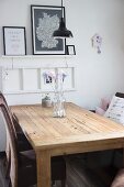 Hand-made arrows with coloured feather flights in retro glass jar on wooden table