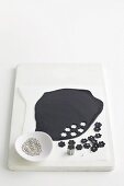 Cut out black fondant flowers and silver beads