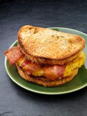 A toasted sandwich with bacon and egg for breakfast (USA)