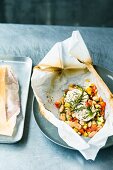 A bean medley with goat's cream cheese on parchment paper