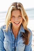 A young woman wearing a light-blue denim shirt