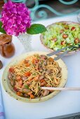 Spaghetti with meatballs and a green salad with cherry tomatoes