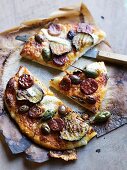 Pizza with grilled vegetables, capers and salami